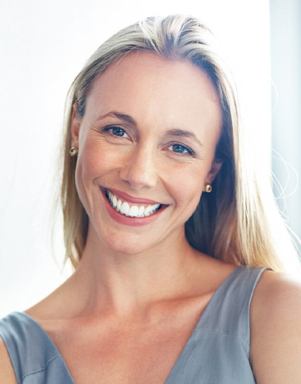 A patient showing a bright smile after teeth whitening